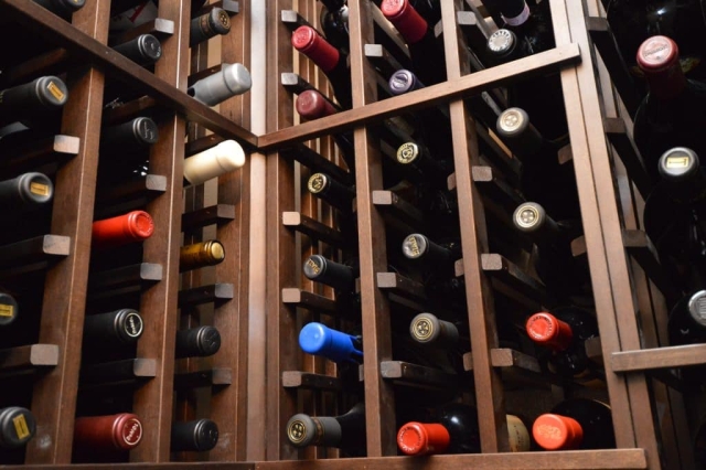 The team built floor-to-ceiling wooden wine racks that make up this pantry wine cellar design to hold your extensive wine collection.