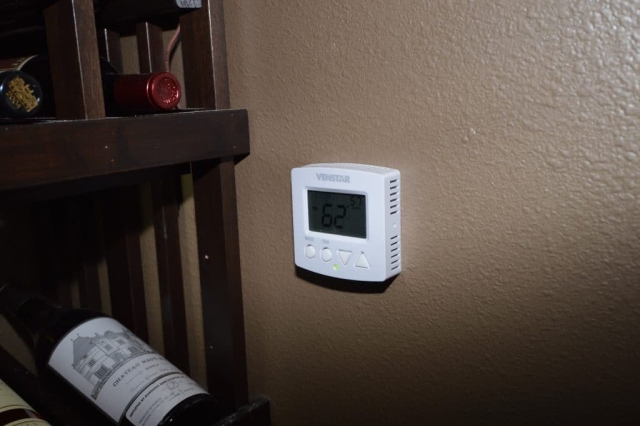 The cooling unit thermostat in this quiet wine cellar allows maximum control of the room's temperature and humidity.